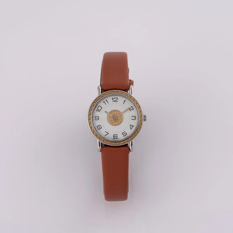 Hermès Sellier 83.03 - Men's watch in steel and yellow gold
